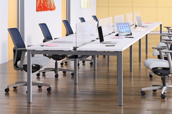 The Empower arranged as 2 long tables with workstations marked by ergonomic chairs