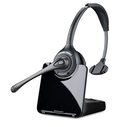 A detail of a black wireless headset resting on its port.
