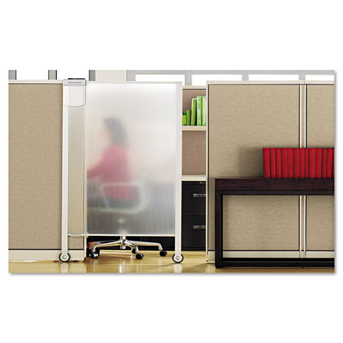 A woman sits at her desk behind a privacy screen.