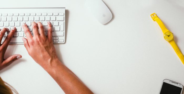 Person typing on a keyboard